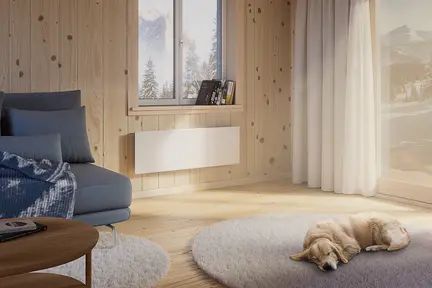 Elradiatorn Wallflex 600 Wifi på väggen i en stuga, vinterlandskap utanför och en hund på golvet